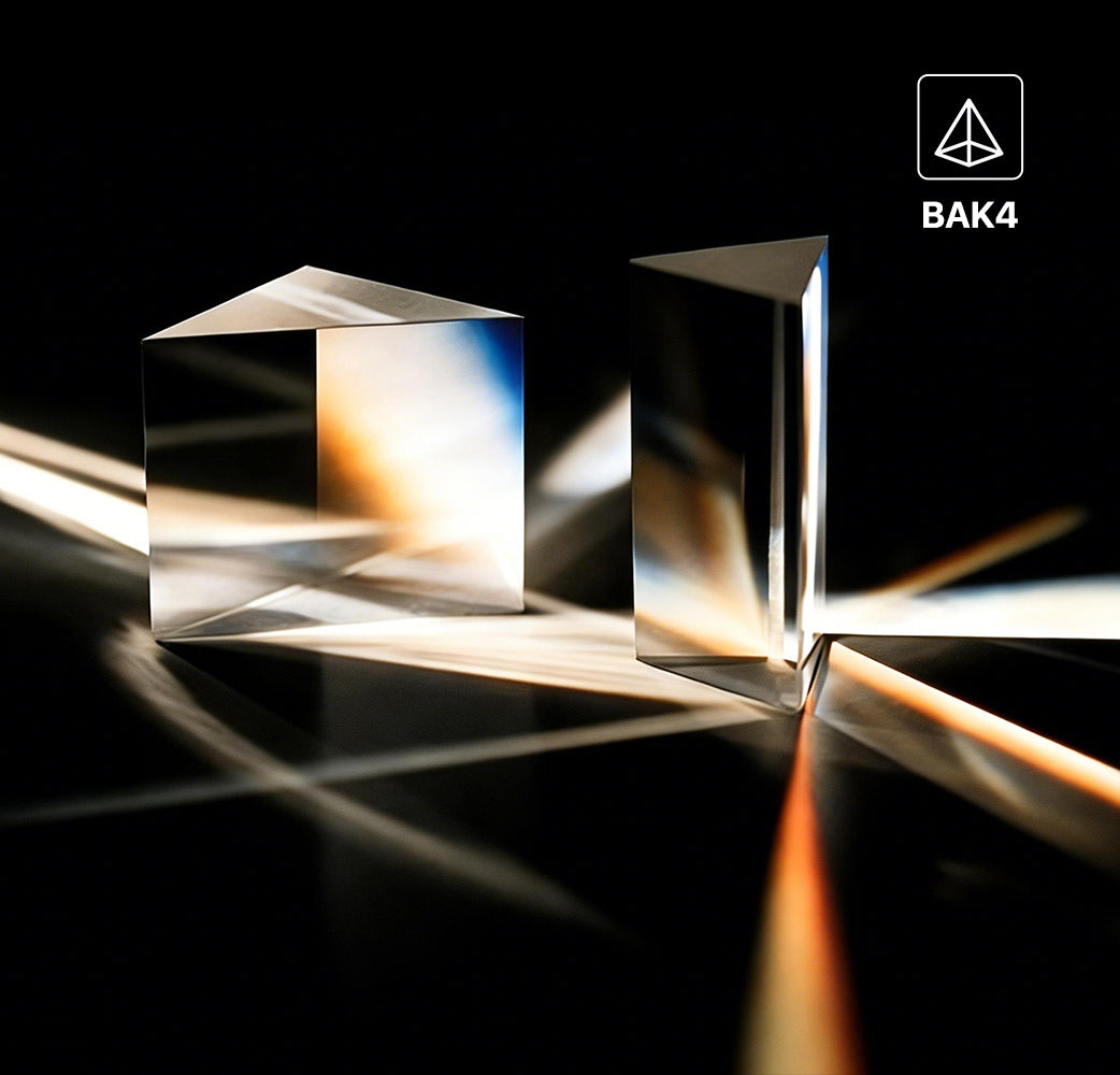Two BAK4 prisms with light effects on a dark background, featuring the BAK4 logo.