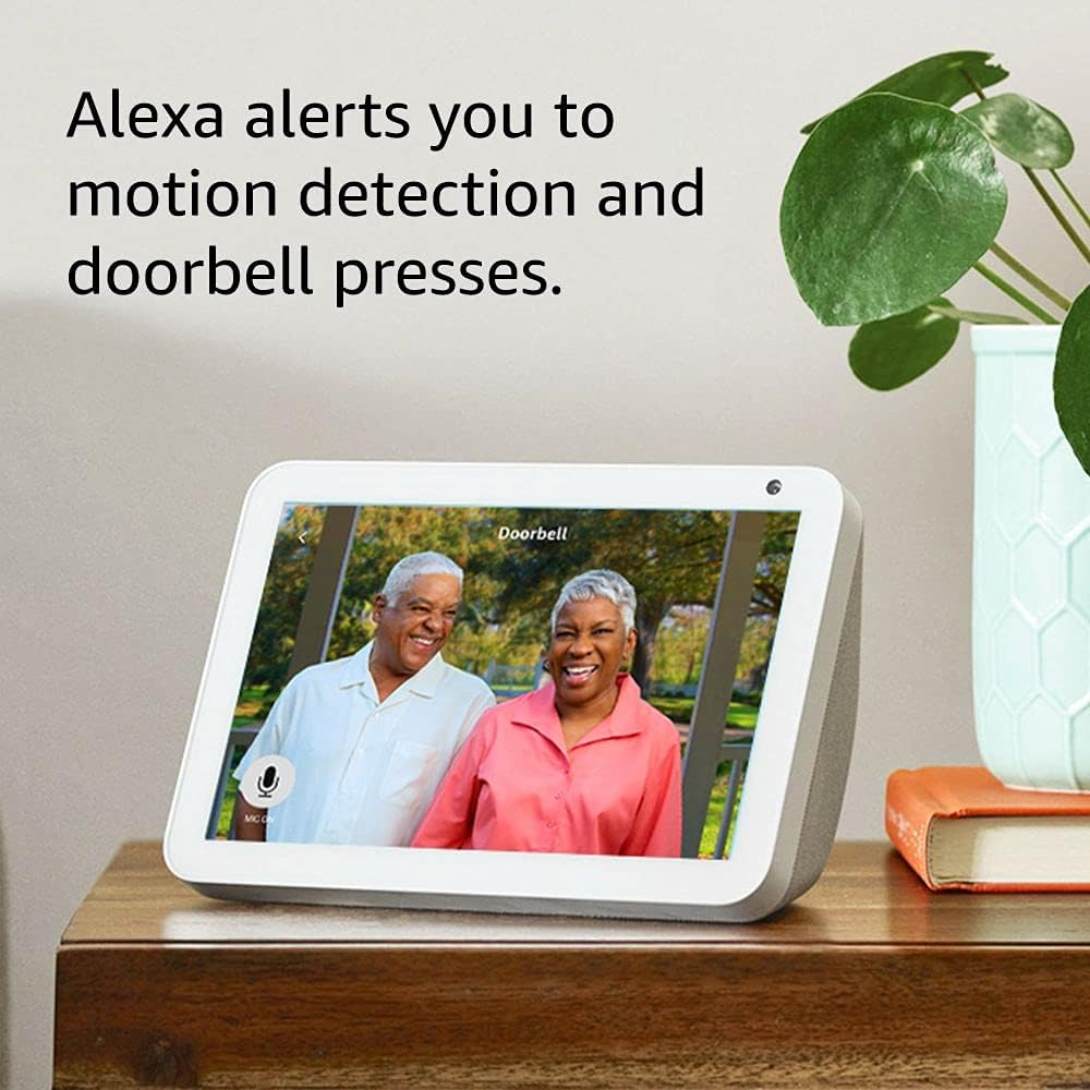 Smart display Bytech showing an elderly couple on a screen with text about Alexa alerts.