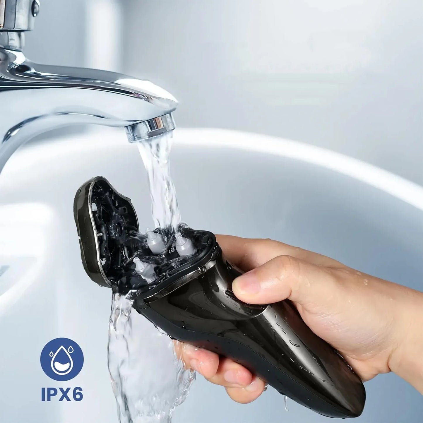 Hand holding a black Bytech Electric Shaver under running water with IPX6 logo.
