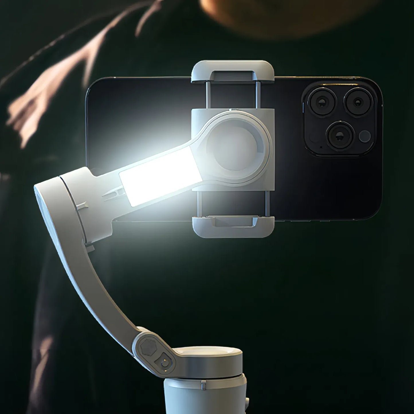 Smartphone with a mounted light and Bytech Gimbal on a dark background