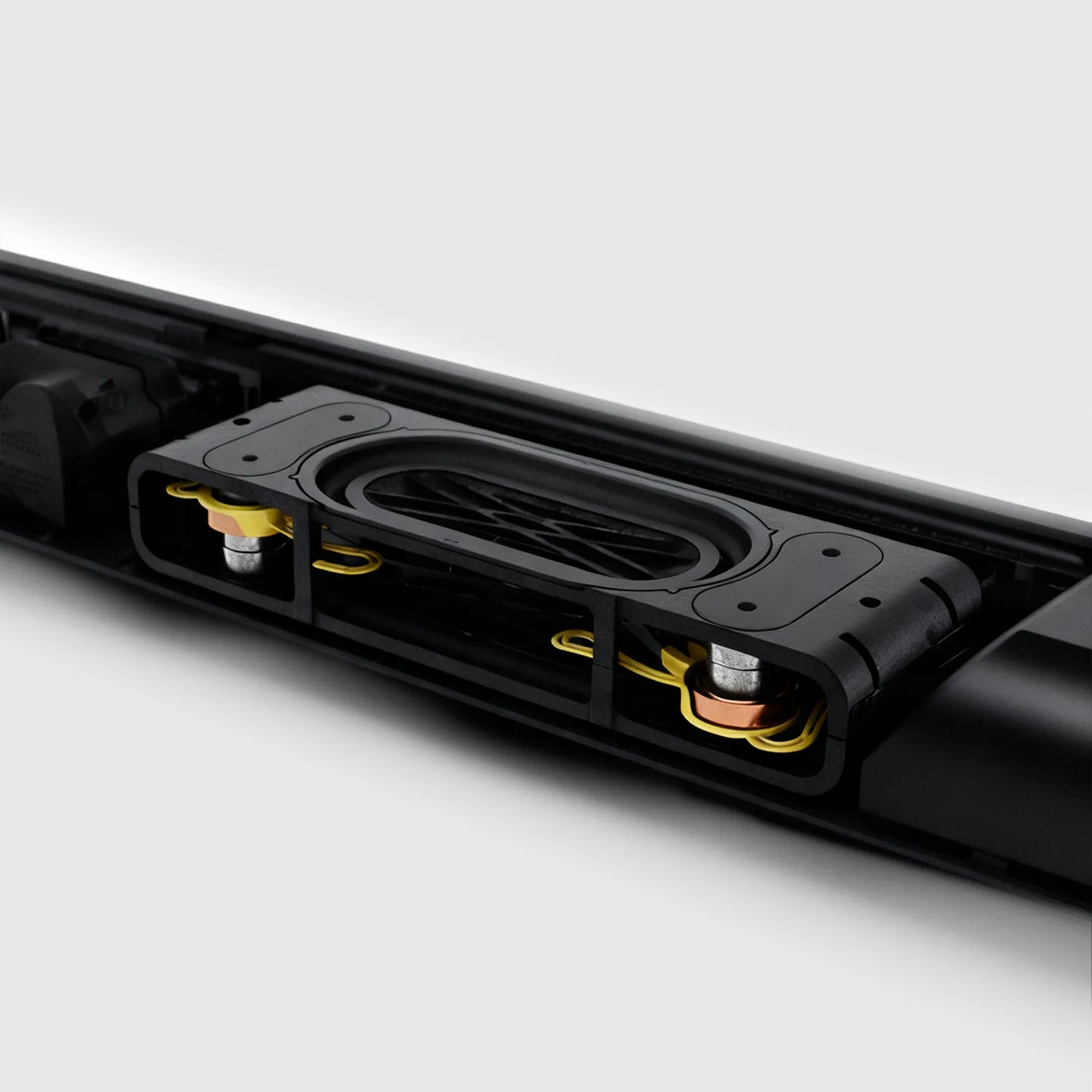 Close-up of a black Kenzor Wireless Soundbar device with visible components on a white background
