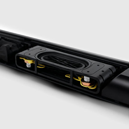 Close-up of a black Kenzor Wireless Soundbar device with visible components on a white background