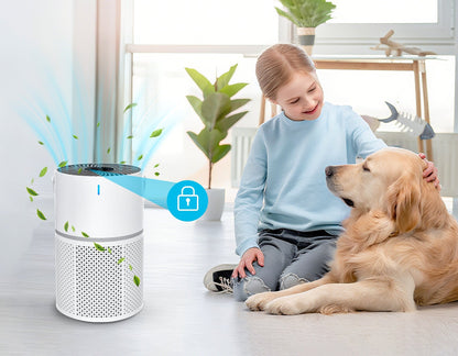 Child and dog sitting on a floor with an Klarity Air Purifier in the foreground