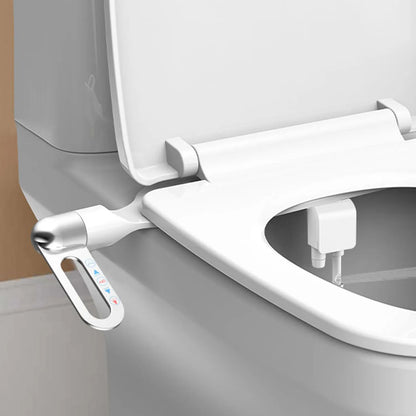 Close-up of a modern toilet seat with a bidet attachment on a neutral background