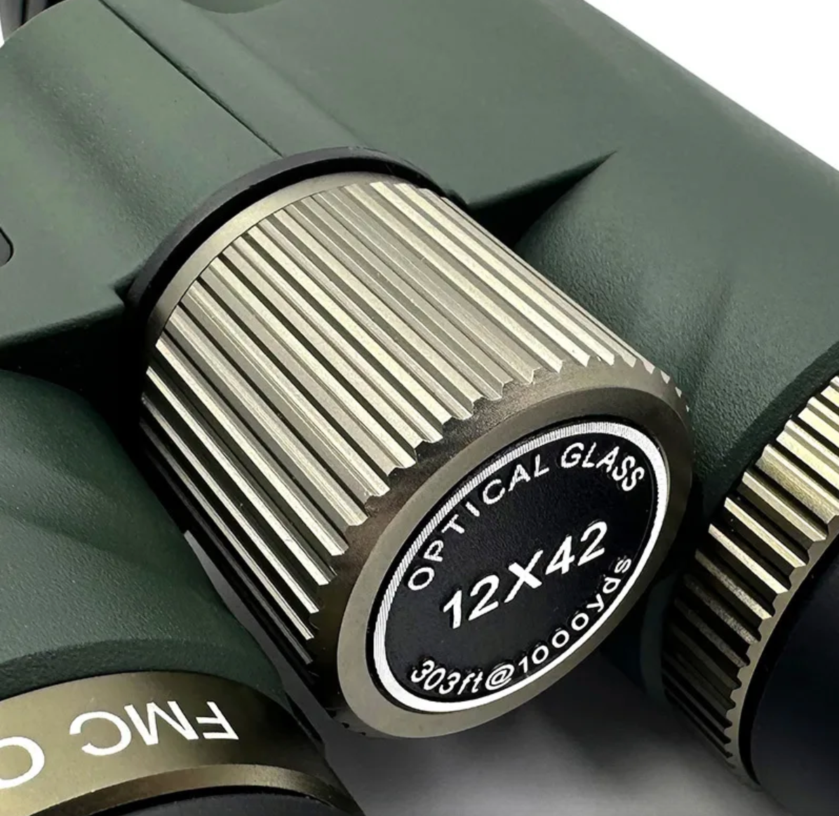 Close-up of a 12x42 Sekoda Binoculars Talon HD lens with 'FMC' branding on a white background.