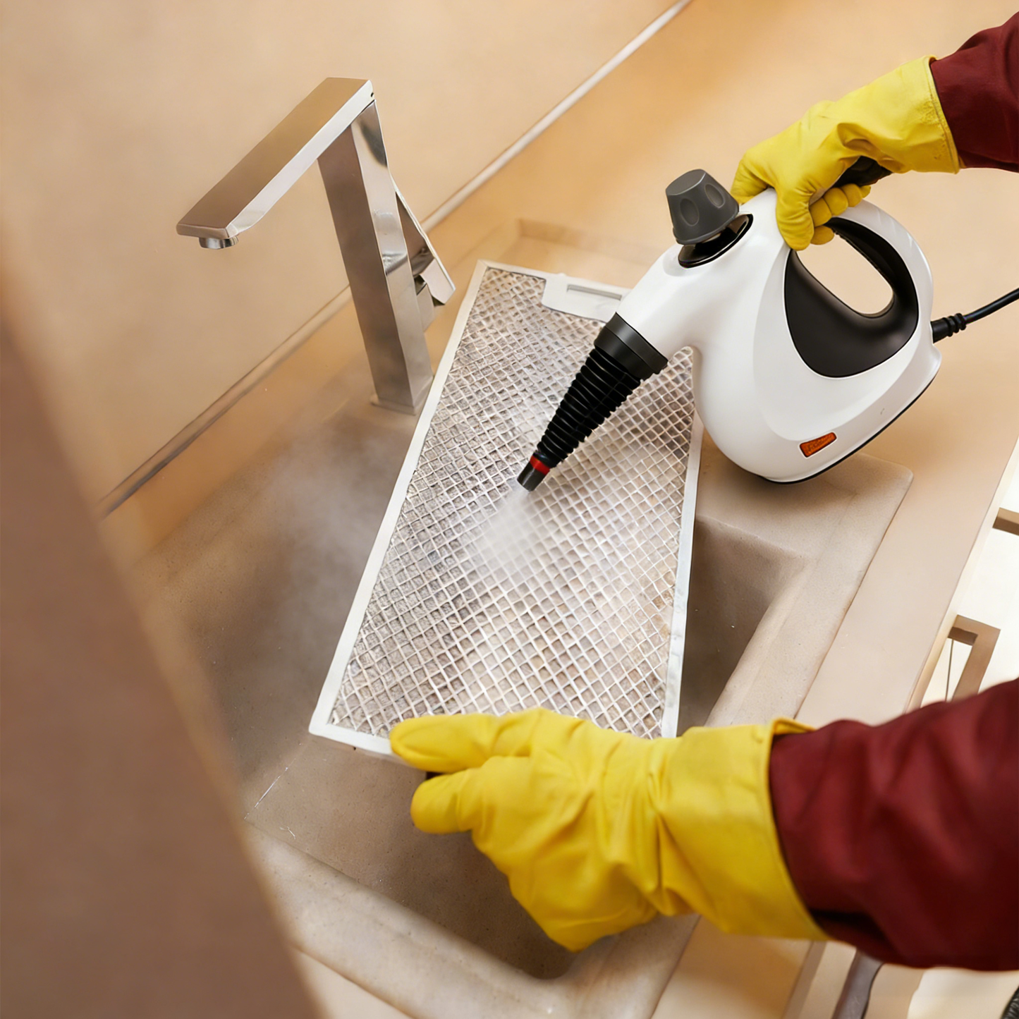 Person Stonnic Steam Cleaner a kitchen filter with a steam cleaner and yellow gloves.