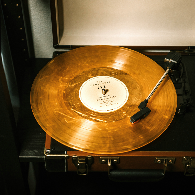 Gold vinyl Auryvox Heritage VT-80 Portable Turntable on a turntable with a visible label.