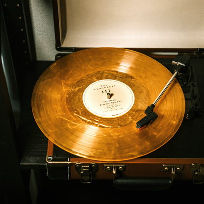 Gold vinyl Auryvox Heritage VT-80 Portable Turntable on a turntable with a visible label.