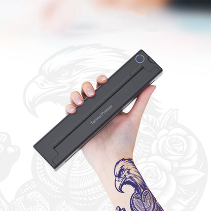 Hand holding a Bytech Tattoo Printer with a blurred background