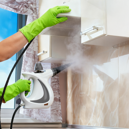 Person cleaning a cabinet with a Stonnic Steam Cleaner, wearing green gloves.