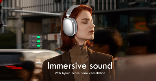 Woman wearing Sintra Noise Cancelling Headphones with 'Immersive sound' text in an urban setting